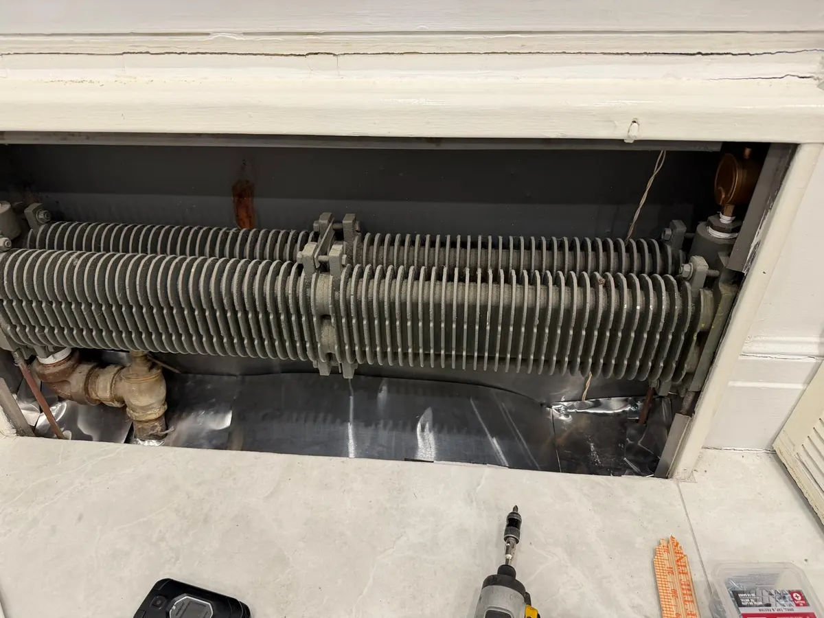 The same radiator cavity with sheet metal fitted to close off the void below
